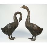Two modern patinated bronze geese, each modelled standing, unsigned, 65cm high, (2).