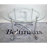 A 20th century glass circular dining table on chrome base, united by 'X' frame stretcher,