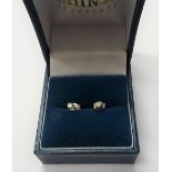 A pair of diamond set single stone earstuds, each claw set with a circular cut diamond,