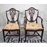 A set of six George III style mahogany shield back dining chairs, to include two carvers,