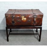 A side table, the brass and polished leather suitcase top on mahogany stand, 93cm wide x 83cm high.