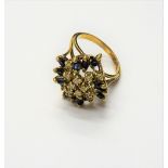 A gold, diamond and sapphire ring, in an abstract design,