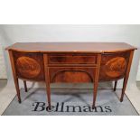 A late George III inlaid mahogany bowfront sideboard, on tapering square supports,