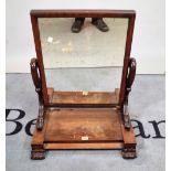 A Regency mahogany breakfront swing frame toilet mirror, on scrolling supports,