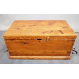 A pine rectangular lift top trunk on plinth base, 90cm wide x 43cm high.