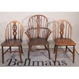 A set of six 20th century Ercol stianed beech stick back dining chairs,