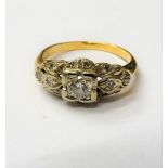 A gold and diamond ring, mounted with the principal circular cut diamond at the centre,