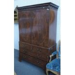 A George III mahogany linen press, the pair of oval panel doors,