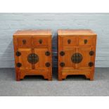 A pair of 19th century Chinese elm bedside cabinets, each with pair of drawers over cupboards,