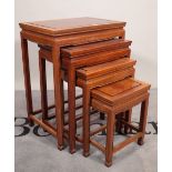 A 20th century hardwood Chinese nest of four tables, the largest 50cm wide x 66cm high.