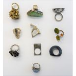 A collection of ten mostly silver rings, in a variety of modern abstract designs,