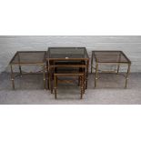 A pair of mid-20th century lacquered brass and smoked glass square occasional tables on fluted