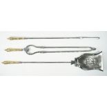 A set of Victorian polished steel fire irons, with brass handles and a pierced shovel plate (78cm),