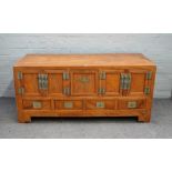 A 19th century Chinese camphor wood low cabinet, with five cupboards over four drawers,