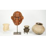 A Japanese plaster mask with inset glass eyes and applied hair on a metal stand, 24cm high,