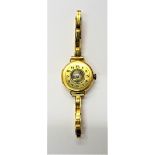 An 18ct gold circular half hunting cased lady's wristwatch, with a jewelled movement,