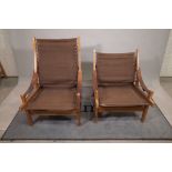 A near pair of 20th century stained beech and canvas low open armchairs, 65cm wide x 98cm high, (2).