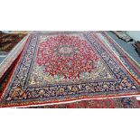 An Esfahan carpet, Persian, the madder field with an ivory and indigo sunburst medallion,