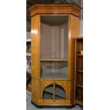 A pair of 20th century stained beech and ebonised floor standing corner cabinets,