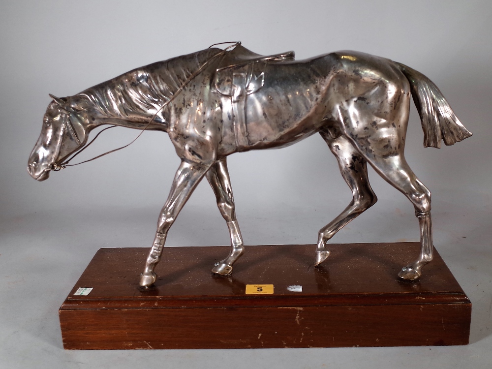 An early 20th century silver plated model of a horse on a oak rectangular plinth base,