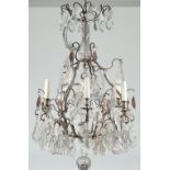 A Victorian style metal and glass mounted six light chandelier hung with shaped clear and amethyst