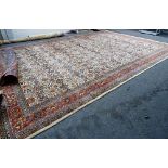 A Kashan carpet, Persian, the ivory field with an allover rosette,