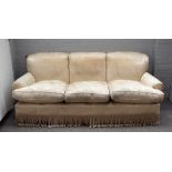 Peter Dugden; a three seat sofa with floral ivory embossed upholstery and tasselled frieze,