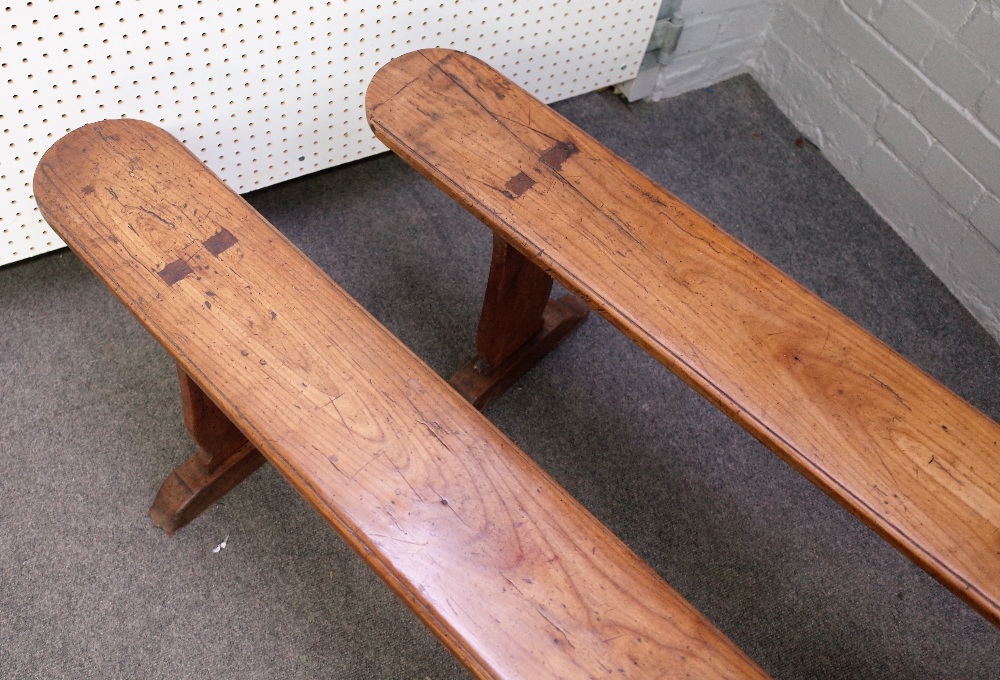 A pair of 19th century French fruitwood benches on silhouette trestle supports, - Image 3 of 3