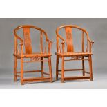 A pair of early 20th century Chinese huanghuali horseshoe back armchairs, with solid seats,