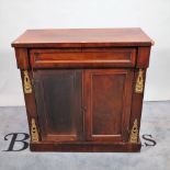 A 19th century gilt metal mounted side cabinet with a single drawer over a pair of cupboard doors,