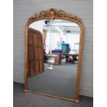 A Victorian gilt framed arch top overmantel mirror, with shell and acanthus scroll crest,
