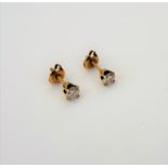 A pair of gold and diamond single stone earstuds, each claw set with a circular cut diamond,