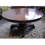 A George IV mahogany centre table, the circular snap top on quatrefoil platform and scroll feet,