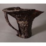 An early 20th century Chinese carved horn libation cup, 16cm wide x 10cm high, (a.f).