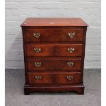 A small 18th century style walnut chest of four long drawers, flanked by canted reeded corners,