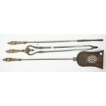 A set of three Victorian steel fire tools with pierced plate and foliate cast brass handles,