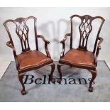 A pair of late Victorian mahogany open armchairs, on ball and claw feet, 58cm wide x 102cm high.