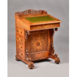 A Victorian floral marquetry inlaid figured walnut Davenport with fret board gallery over sloped