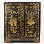 A Japanese table cabinet, circa 1900, chinoiserie decorated against an ebonised rectangular body,