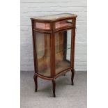 A late 19th century French gilt-metal mounted mahogany concave fronted bijouterie cabinet with