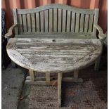 Garden furniture; a teak arched back garden bench,