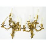 A pair of gilt bronze rococo style five branch wall appliques, 19th century,