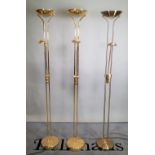 A group of three 20th century brass floor standing lamps, each with angle poise light,