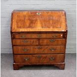 An 18th century figured walnut bureau, the fitted interior over one long,