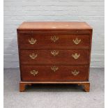 An 18th century oak chest, the brushing slide over three long graduated drawers, on bracket feet,
