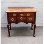 A mid-18th century mahogany and walnut lowboy, the shaped frieze with four drawers on club supports,