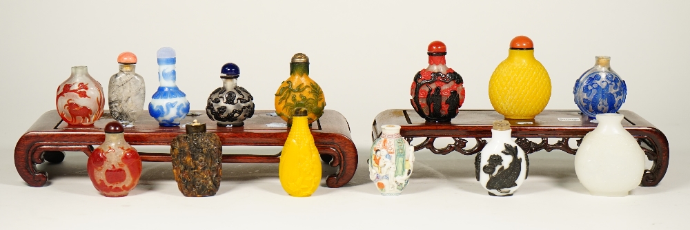 A group of fourteen Chinese snuff bottles, 20th century, including eight glass overlay examples,