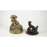 A Chinese bronze cover, Ming dynasty, 17th century, surmounted by a Buddhist lion,