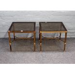 A pair of mid-20th century lacquered brass and glass square occasional tables on reeded supports,