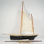 A small pond yacht, English, 20th century with single main mast,